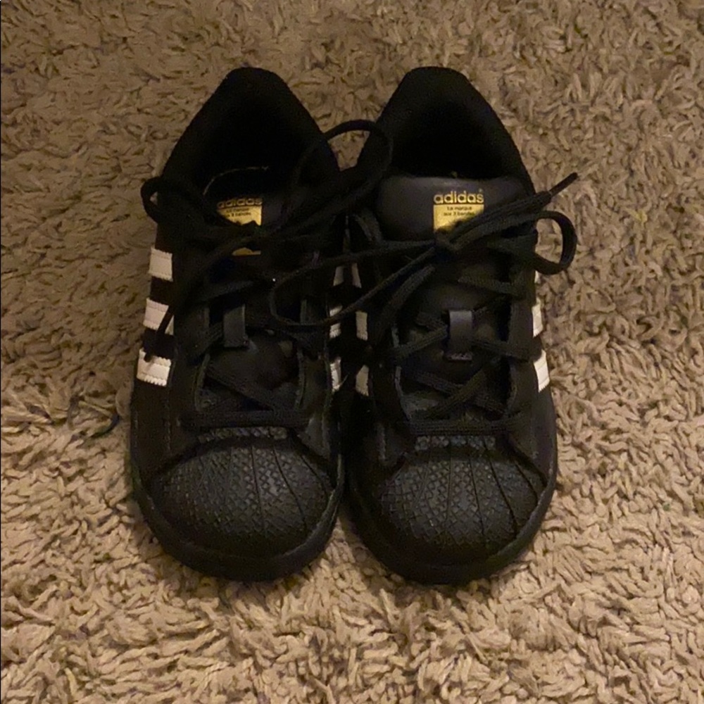 black Adidas Superstar shoes
